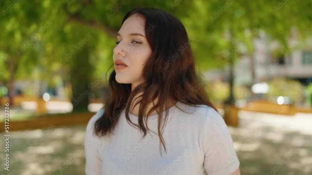 Young woman walking with relaxed expression at park Young woman walking with relaxed expression at park