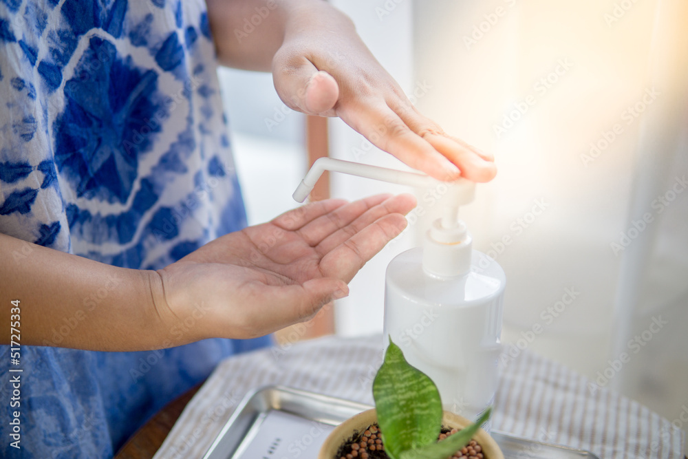 woman presses hand sanitizer to prevent disease woman presses hand sanitizer to prevent disease