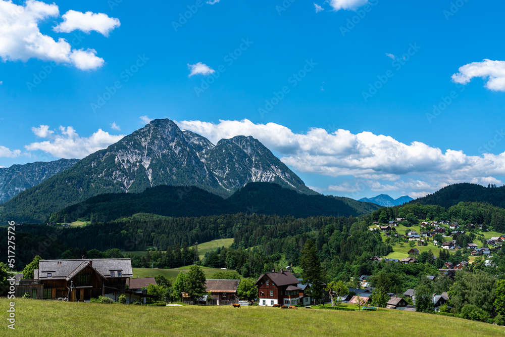 Naklejka premium Beautiful idyllic panorama view of village near Altaussee with the peak Sarstein in background on a sunny summer day with blue sky cloud, Styria, Austria