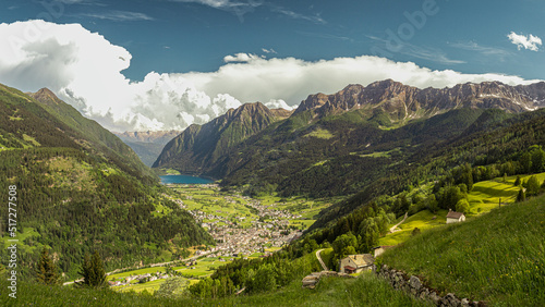 Idyllic landscape in the Alps with fresh green meadows and blooming flowers and d mountain tops in the background