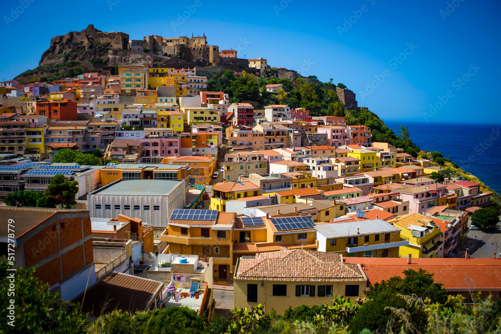 view of the city of Castelsardo, Sassari, Sardegna. Colorful houses on the hill with the sea behind. Castle on top.