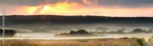 Foto Landscape view of fog over remote field with copy space at sunset