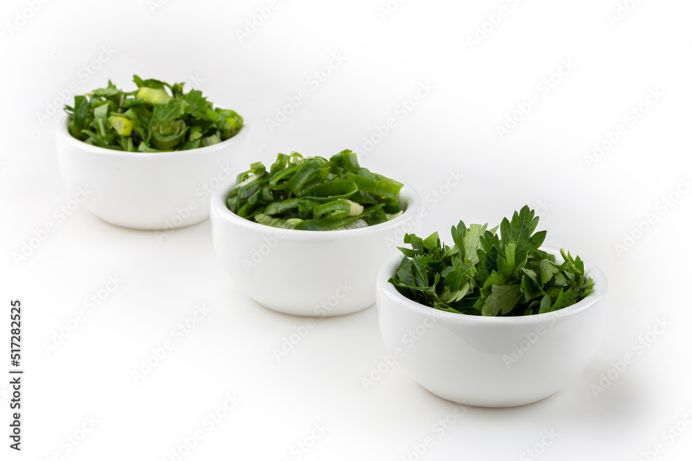 Sliced cilantro, chives and parsley in ramekin. Sliced cilantro, chives and parsley in ramekin.