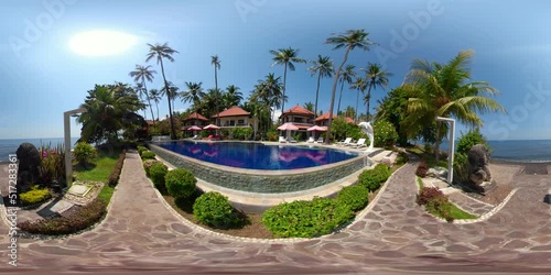 vr360 swimming pool in luxury hotel with sun beds by sea. tropical resort with pool. Travel concept. photo