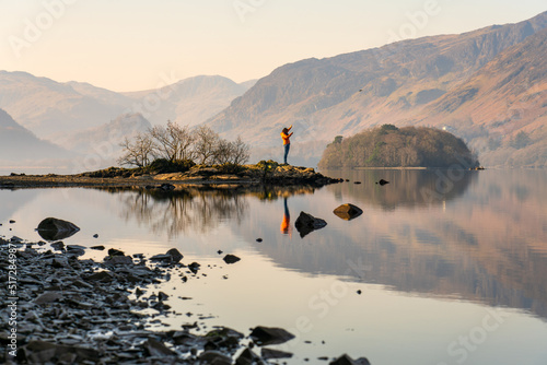Print op canvas Female tourist at Derwent water Lake in Lake District. England