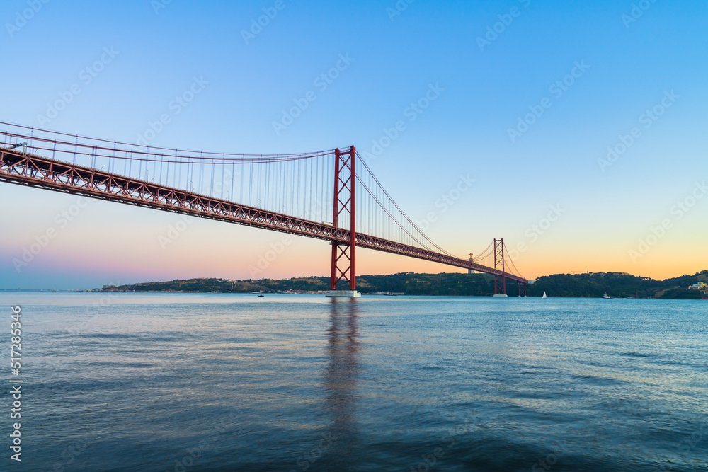 The 25 de Abril bridge at sunset over the Tajo River in Lisbon. Portugal