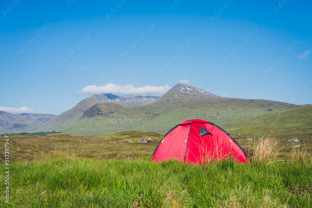 Red tent in Scottish highlands near Rannoch Moor moorland 