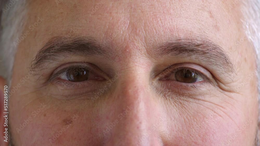 Closeup of eyes and mature man wearing eye contacts as an optometry vision or optician prescription solution. Headshot, face and skin or wrinkles detail of a man looking forward, watching and gazing Closeup of eyes and mature man wearing eye contacts as an optometry vision or optician prescription solution. Headshot, face and skin or wrinkles detail of a man looking forward, watching and gazing