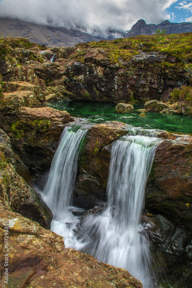 Cascading waterfalls and green water of the Fairy Pools in Isle of Skye 