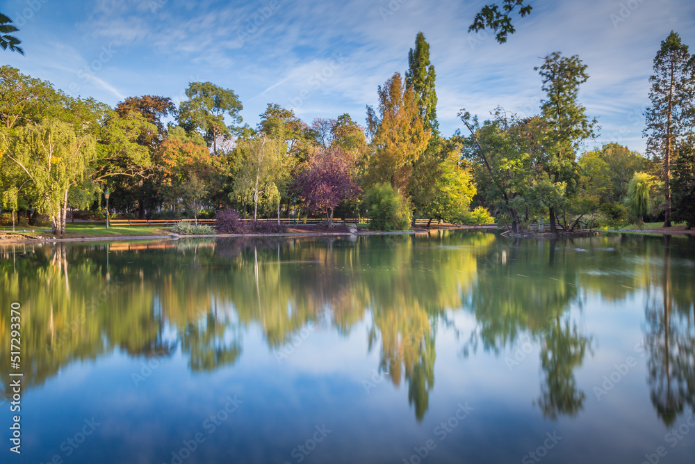 Reflection Lake in Stadtpark, Vienna, at peaceful sunrise, Austria