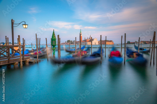 Grand canal with gondolas at peaceful sunset, Venice Lagoon, Italy