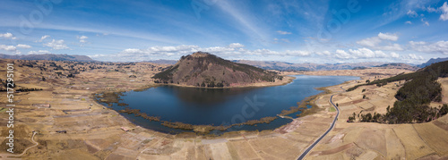 Aerial view of Huaypo Lake. Water source in the high Andes of Cusco Peru. Sunny day in Andean rural landscape.