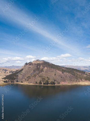 Aerial view of Huaypo Lake. Water source in the high Andes of Cusco Peru. Sunny day in Andean rural landscape.