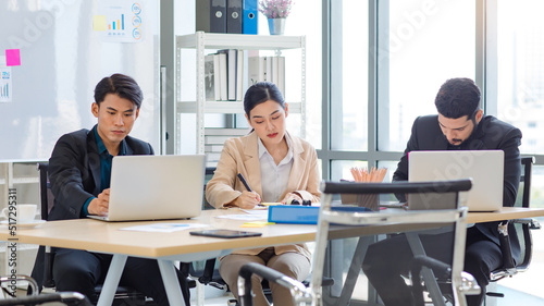 Group of millennial Asian Indian multinational multicultural male and female businessman businesswoman teamwork in formal suit sitting smiling brainstorming meeting together in office conference room