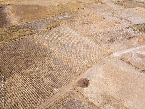 Aerial view of rural landscape in Cusco Peru. Peruvian agriculture fields during dry season in high Andes.
