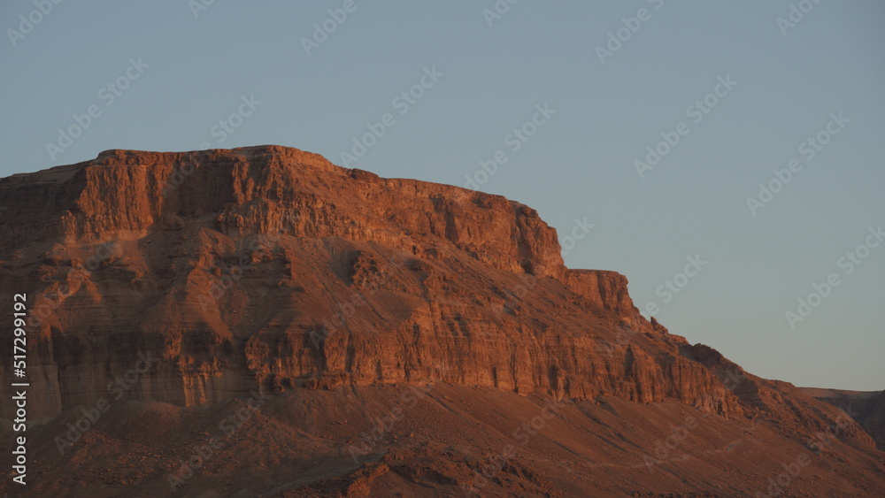 Mountains near Dead Sea seashore at sunrise. Red mountains in the morning