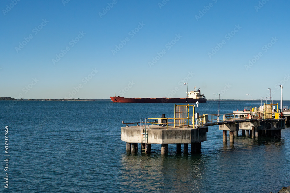 Bulk carrier ship passing the grain wharf at Gladstone heading into the harbour.