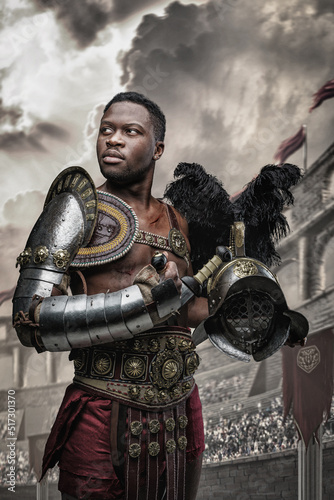 Shot of legendary african gladiator holding two swords in cross in arena looking at camera.