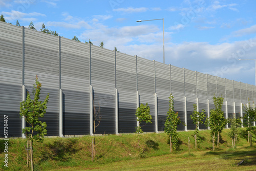 A noise barrier (also called a soundwall, noise wall, sound berm, sound barrier, or acoustical barrier) is an exterior structure designed to protection of people against noise. photo