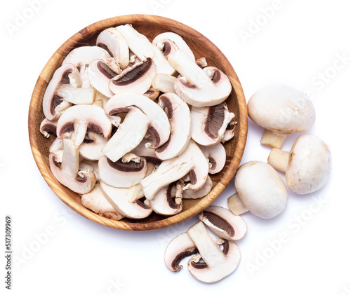 Fresh white champignon mushrooms in wooden bowl isolated on white background photo