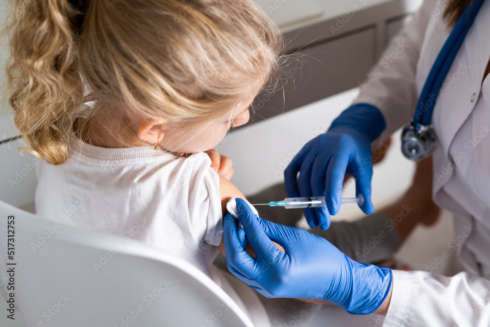 vaccination of children, a little girl at a doctor's appointment, an ...