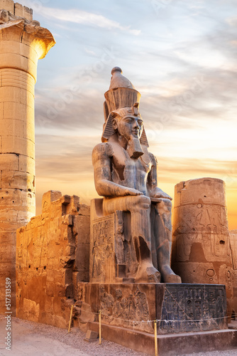 Tela Seated statue of Ramesses II by the Luxor Temple entrance, sunset scenery, Egypt