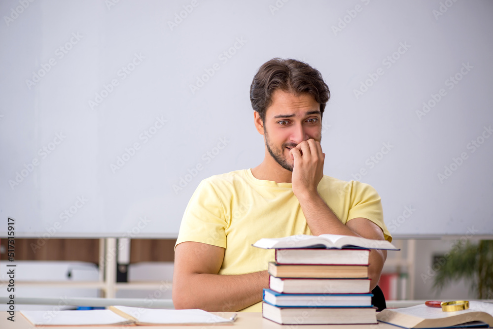 Young male student preparing for exams in the classroom Young male student preparing for exams in the classroom