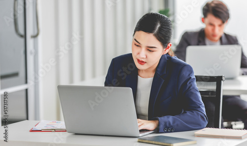 Indian stressed depressed exhausted bearded male businessman sitting at workstation with laptop computer close eyes hold hand on head feeling tired and sleepy after working late overtime last night