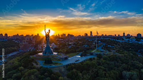 Aerial view to the Motherland statue in the Kiev while  summer sunset. The well-known landmarks in Kyiv. Historical monument of Soviet union. Beautiful city Kiev while sunset. photo