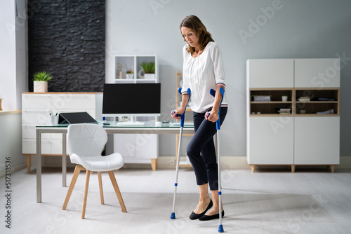 Vászonkép Injured Woman Walking With Crutches