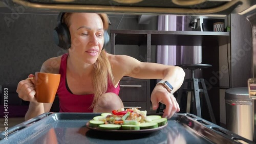 Female cook salat in oven at the kitchen