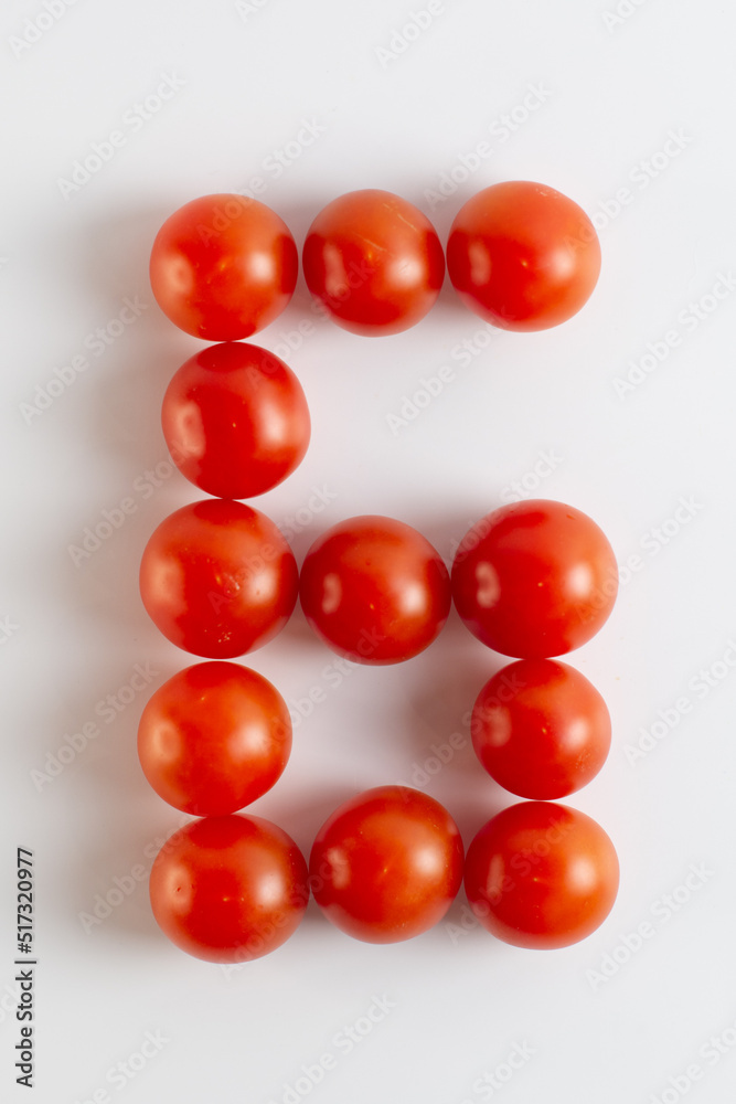 Number six. A figure of cherry tomatoes on a white background. Tomatoes close-up. Tomatoes in the form of the Number six Number six. A figure of cherry tomatoes on a white background. Tomatoes close-up. Tomatoes in the form of the Number six