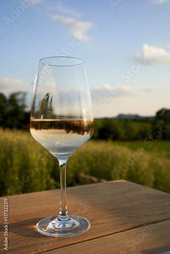 Glass of white wine on the table outdoors