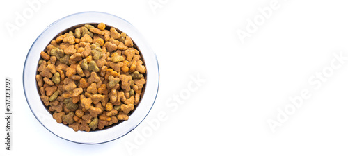 Round metal bowl for pets with dry food. Isolated on white background. View from above. Full plate with a slide