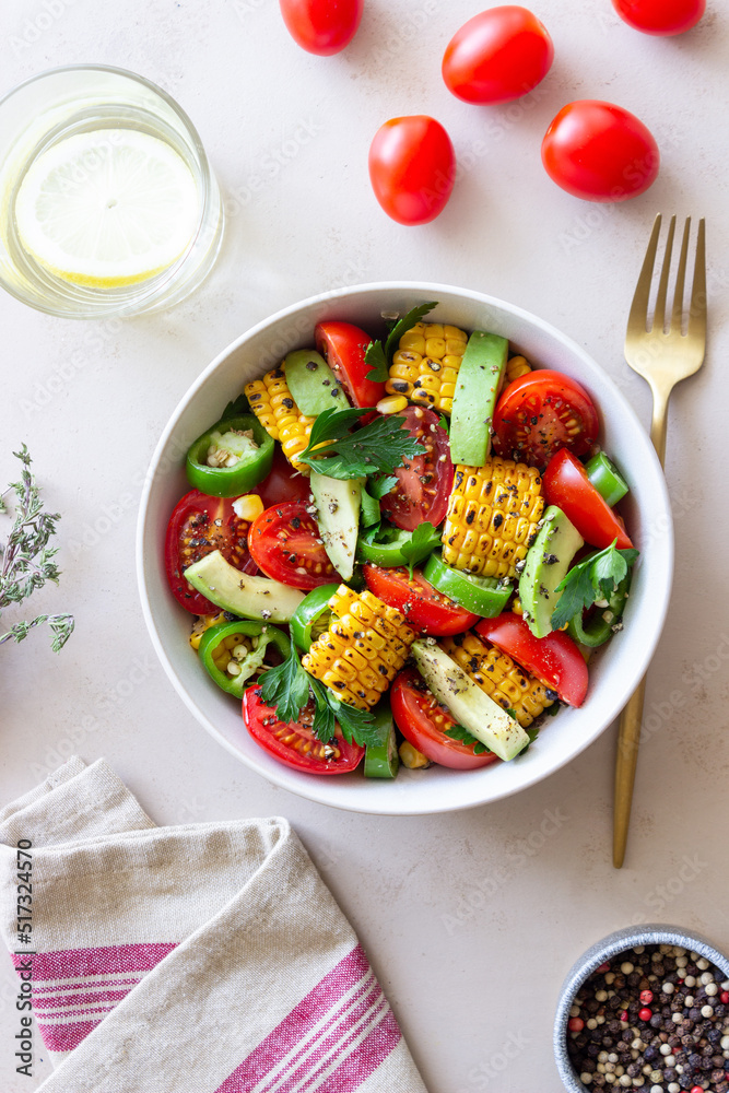 Salad with corn, avocado, tomatoes, peppers and parsley. Healthy eating. Vegetarian food. Salad with corn, avocado, tomatoes, peppers and parsley. Healthy eating. Vegetarian food.