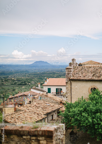 Top view of the Italian village of Nerola against the backdrop of a green valley and mountains. Ancient European architecture, old roof tiles. photo