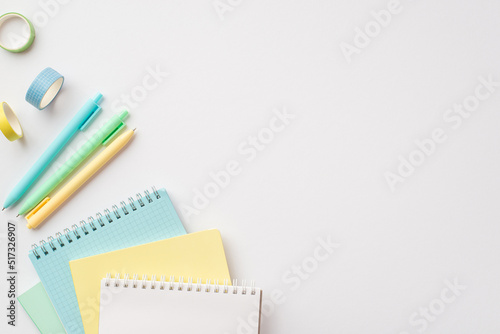 School supplies concept. Top view photo of colorful stationery planners pens and adhesive tape on isolated white background with empty space