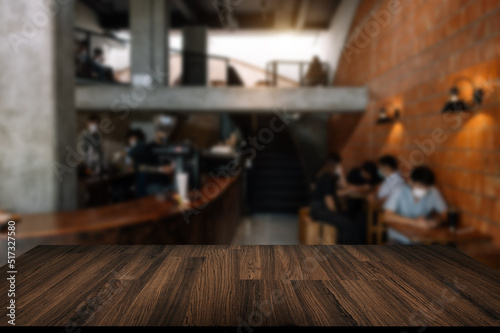 Empty top of wooden shelves on coffee shop ,tree front view background. For product display blur background image, for product display montage..