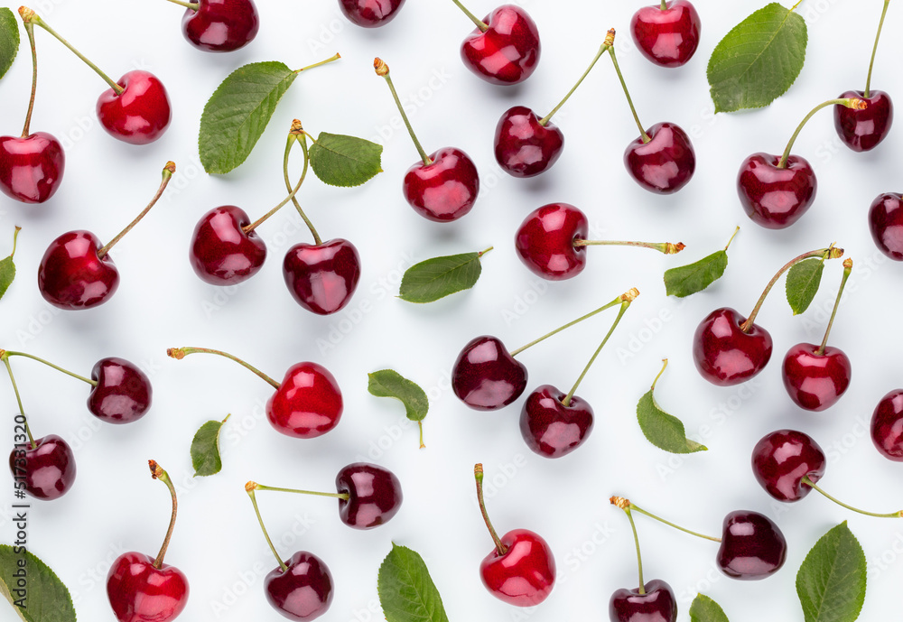 Cherry berries on a pastel background top view. Background with a cherry on a sprig, flat lay Cherry berries on a pastel background top view. Background with a cherry on a sprig, flat lay