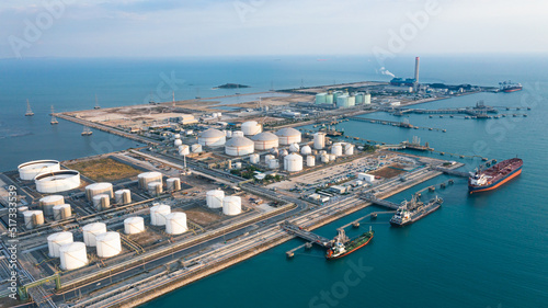 Aerial view of Oil refinery or petroleum refinery in the industrial factory of heavy industry, oil production plant. Crude oil tanker and Gas tanker container ship, coal powered electricity plant