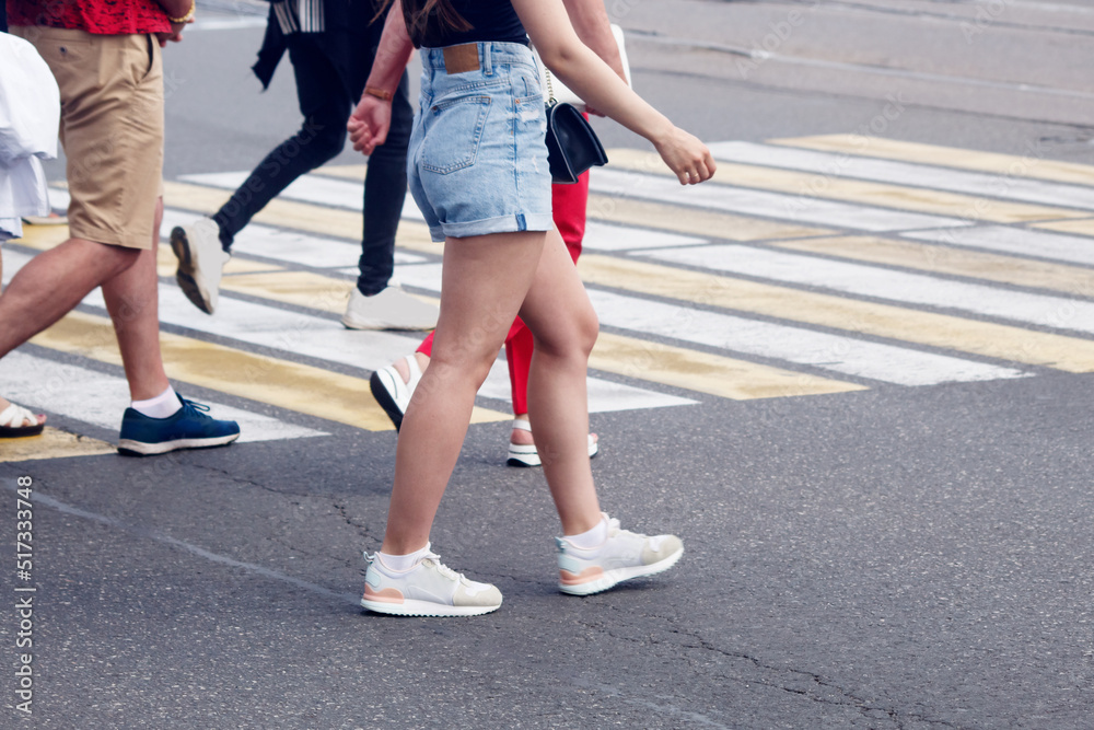 people crossing the road at a pedestrian crossing