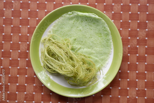 Thai Cotton Candy Burrito or Roti Sai Mai in a dish set on a wooden table and space