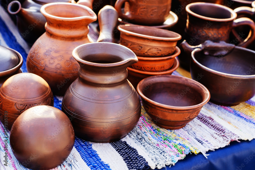Clay pots and jugs in retro style. Trade in crockery and pottery. Selective focus. Close-up