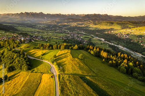 Farm landscape on rolling hills in Tatras mountains at summer sunrise