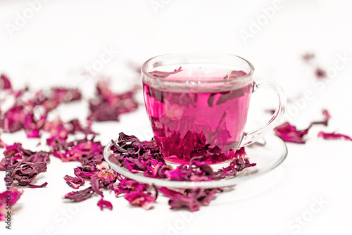 Infusion of hibiscus sabdariffa on a white background. Tea drink from the Sudanese rose, karkade