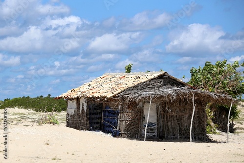  In the sand of the beach rustic house made of wattle and daub and adobe in northeastern Brazil. Poor housing used by fishermen near the sea.