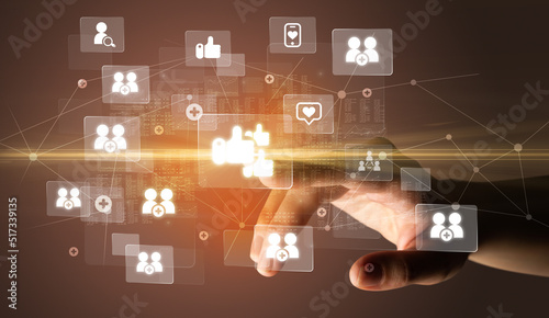 Wallpaper Mural Hand pressing social media multimedia application screen with media icons on futuristic concept Torontodigital.ca