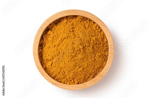 Turmeric powder in wooden bowl on white background. Top view 