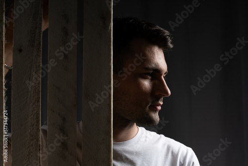 male portrait. profile of a guy on a black background. backlit