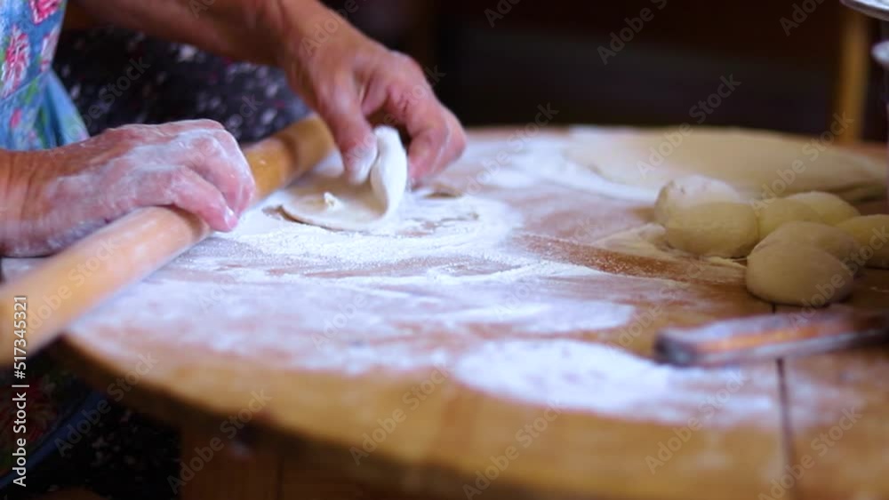 Women's hands in the process of cooking kutaba or chebureks, minced meat and onions in the dough. Azerbaijani, Tatar, Caucasian, Greek cuisine. Women's hands in the process of cooking kutaba or chebureks, minced meat and onions in the dough. Azerbaijani, Tatar, Caucasian, Greek cuisine.